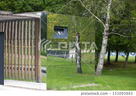 Mirror-clad building reflecting the surrounding nature Mirror-clad building reflecting the surrounding nature 131093883