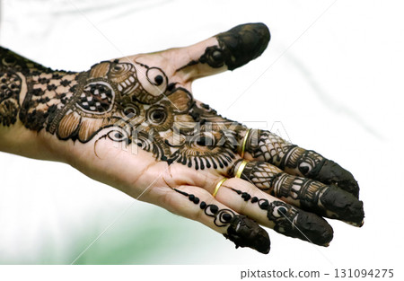 Picture of human hand being decorated with henna tattoo,Decorated Mehendi cone in Indian wedding ceremony Picture of human hand being decorated with henna tattoo,Decorated Mehendi cone in Indian wedding ceremony 131094275