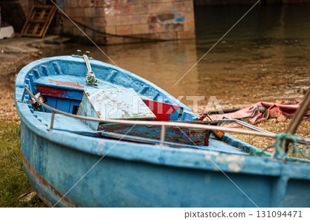 Old blue wooden boat on the shore 131094471