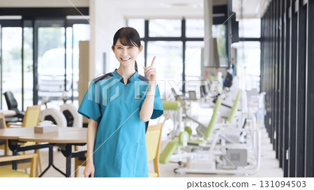 Asian care worker pointing at care facility 131094503