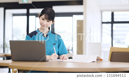 Asian caregiver studying Asian caregiver studying 131094511