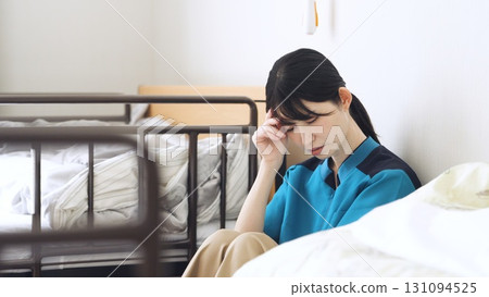 Asian caregiver tired from care work 131094525