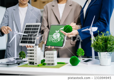 business team people planning and discussing on recycle reduce reuse policy symbol in office meeting room. Green business company and Solar Energy business team people planning and discussing on recycle reduce reuse policy symbol in office meeting room. Green business company and Solar Energy 131094945