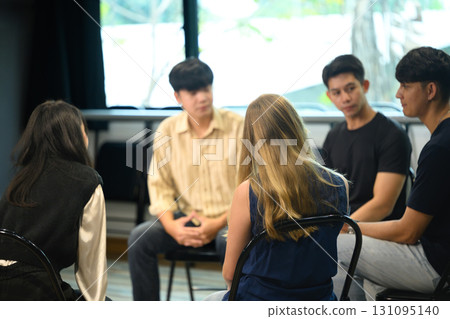Group therapy session with diverse participants seated in a circle, engaging in open discussion Group therapy session with diverse participants seated in a circle, engaging in open discussion 131095140