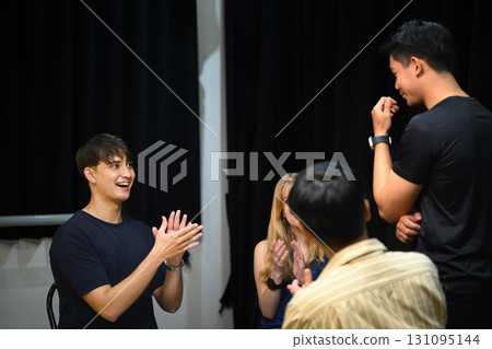 Psychotherapy group session where participants clap and encourage a member sharing his story 131095144