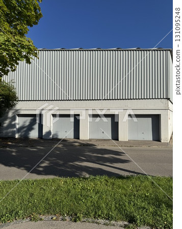 Modern Industrial Building Facade in Clear Blue Sky Modern Industrial Building Facade in Clear Blue Sky 131095248