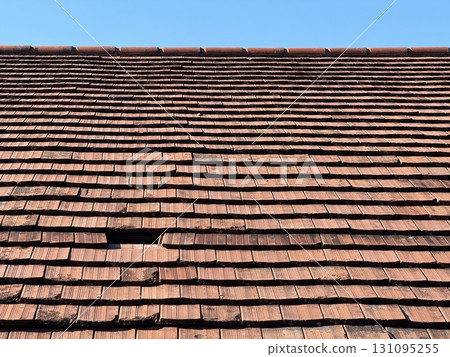 A Classic Clay Tile Roof against a beautiful Blue Sky backdrop 131095255