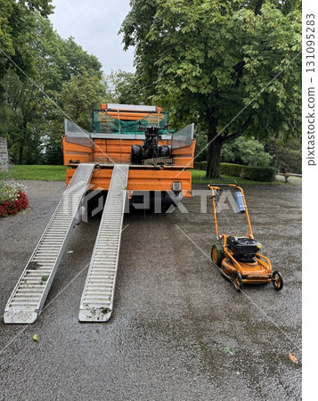 Heavy Machinery Setup with Loading Ramps on a Driveway Heavy Machinery Setup with Loading Ramps on a Driveway 131095283