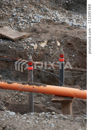 Pipe is sticking out of the ground in a muddy area 131095369