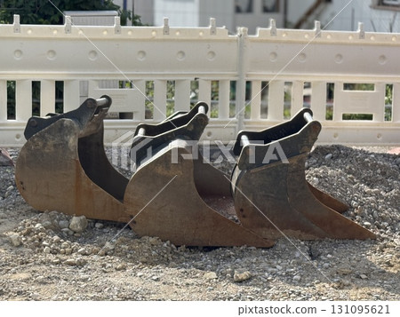 Excavator Buckets Utilized on a Construction Site for Various Purposes and Tasks Excavator Buckets Utilized on a Construction Site for Various Purposes and Tasks 131095621