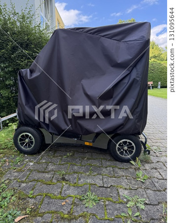 A covered trailer rests on a charming cobblestone pathway, displaying an attractive exterior 131095644