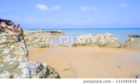 TitleRocky Shore and Sandy Beach on a Sunny Day 131095678