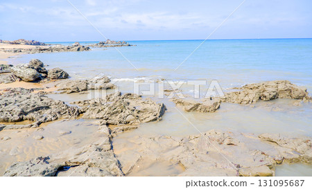 Serene Coastal Bay with Rocky Shore and Blue Ocean 131095687