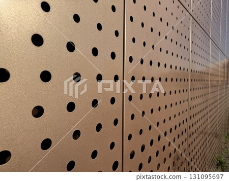 A Modern Perforated Metal Wall That Features a Distinct, Unique Design Aesthetic In Architecture 131095697