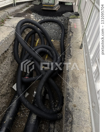 The Intricate Arrangement of Numerous Black Cables Spread Across a Busy City Street 131095704