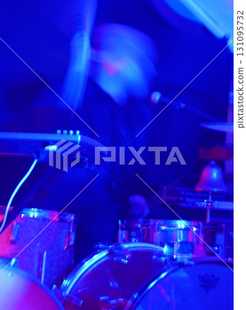 Man is playing drums in a band 131095732