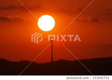 Large wind turbine is silhouetted against a beautiful sunset Large wind turbine is silhouetted against a beautiful sunset 131095752