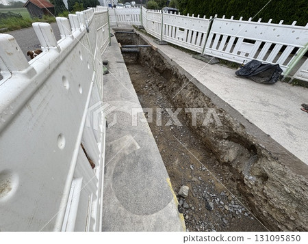 Construction Site Featuring an Exposed Trench for Essential Utility Work Being Conducted Construction Site Featuring an Exposed Trench for Essential Utility Work Being Conducted 131095850
