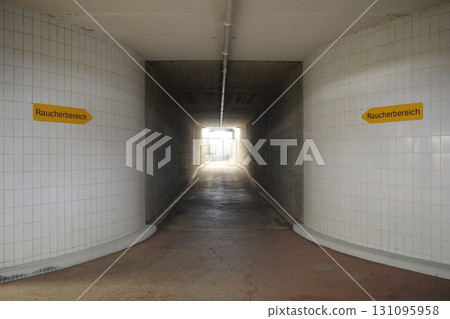 Tunnel with two signs on the wall, one of which says "Pawm Berch" 131095958