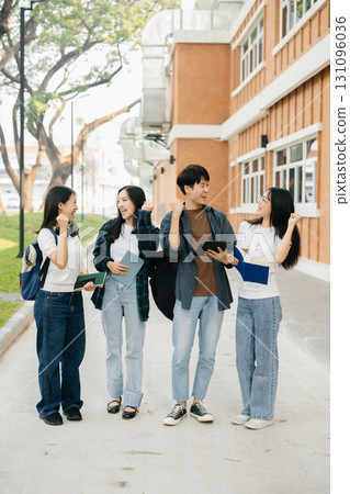 Young Asian college students and a female student group work at the campus park 131096036