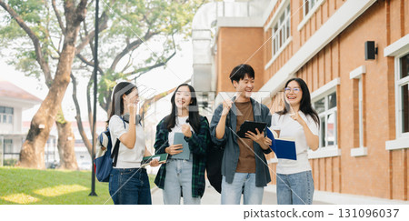Young Asian college students and a female student group work at the campus park 131096037