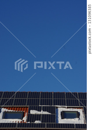 Blue sky with a house with two windows and solar panels on the roof 131096385
