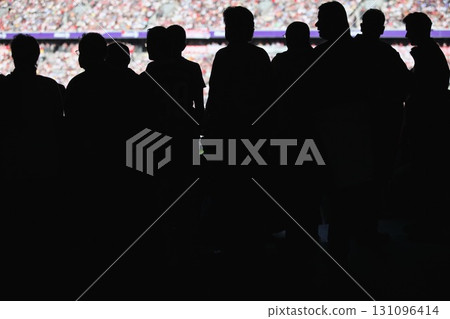 Group of people are standing in a stadium Group of people are standing in a stadium 131096414