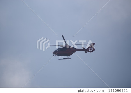 Red helicopter is flying in the sky Red helicopter is flying in the sky 131096531