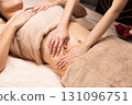 Young Asian woman getting a belly oil massage. 131096751