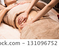 Young Asian woman getting a belly oil massage. 131096752