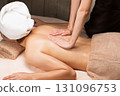 A young Asian woman is getting a back oil massage. 131096753