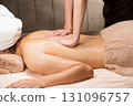 A young Asian woman is getting a back oil massage. 131096757