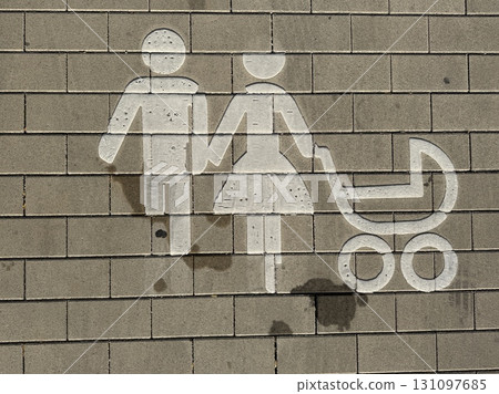 An artistic and colorful depiction of a Family Symbol featuring a Baby Stroller painted on a wall 131097685