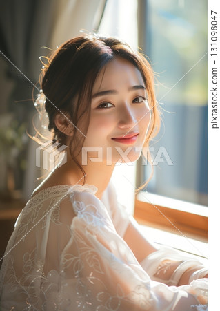 A stylish, beautiful Japanese woman relaxing by the window (vertical photo) 131098047