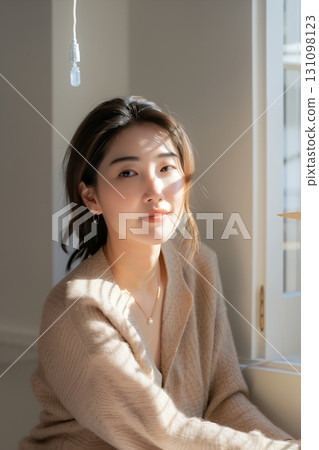 A stylish, beautiful Japanese woman relaxing by the window (vertical photo) 131098123