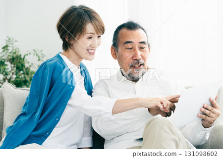 Senior couple looking at laptop 131098602