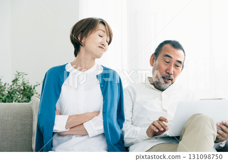 Senior couple arguing on the sofa 131098750