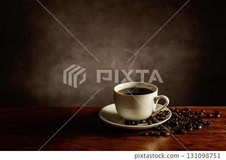 Hot coffee and coffee beans on the table 131098751