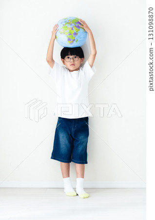 Boy holding a globe ball Boy holding a globe ball 131098870