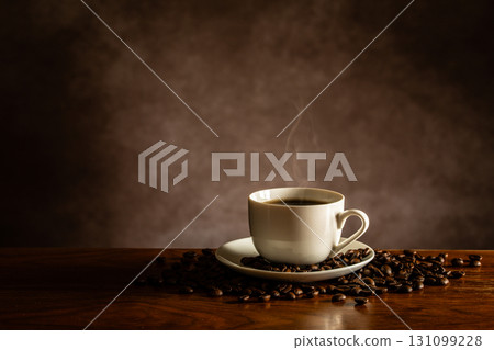 Hot coffee and coffee beans on the table 131099228