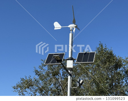 Eco-friendly street lighting systems harness solar energy during the day and wind power at night, offering a renewable, cost-effective way to illuminate city streets. 131099523