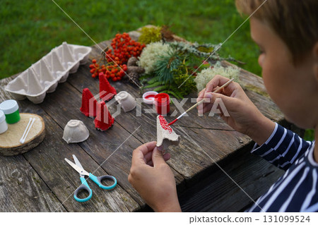 Eco-friendly craft ideas for kids, focusing on reuse, natural materials, and imagination. 131099524