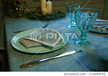 Festive table setting with a napkin on a plate 131099526