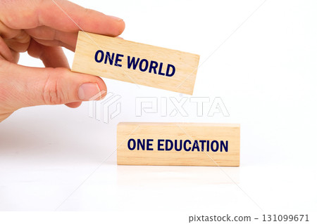 Education and knowledge concept. Copy space. ONE WORLD ONE EDUCATION made from blocks with hand on white background Education and knowledge concept. Copy space. ONE WORLD ONE EDUCATION made from blocks with hand on white background 131099671