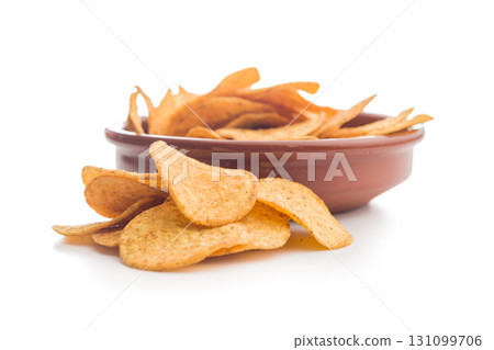 Crispy potato chips isolated on white background. Crispy potato chips isolated on white background. 131099706