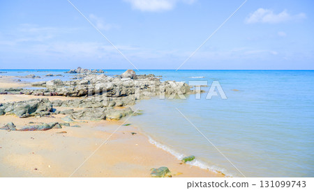 TitleTropical Rocky Beach with Coastal Buildings TitleTropical Rocky Beach with Coastal Buildings 131099743