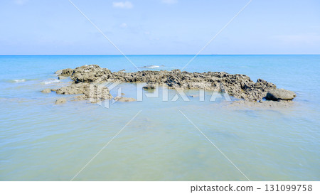 Long Coastal Rock Formation in a Calm Tropical Sea 131099758