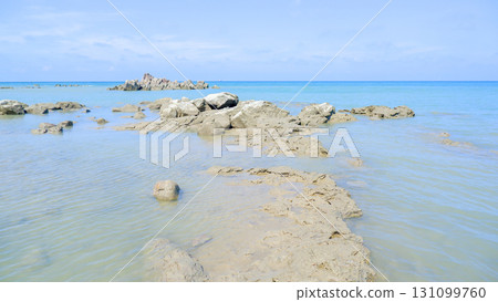 Flat Coastal Rock Formation in a Calm Tropical Sea Flat Coastal Rock Formation in a Calm Tropical Sea 131099760