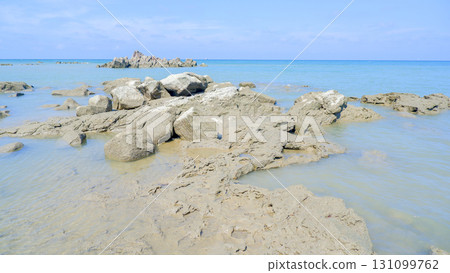 Rugged Coastal Shoreline with a Distant Rock Formation Rugged Coastal Shoreline with a Distant Rock Formation 131099762