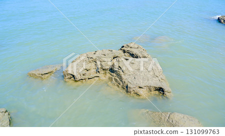 Rugged Coastal Rock in Clear Shallow Water 131099763
